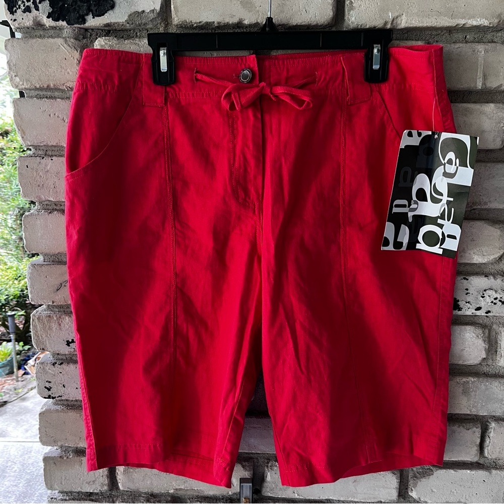 Activology orange long Bermuda shorts below knee.